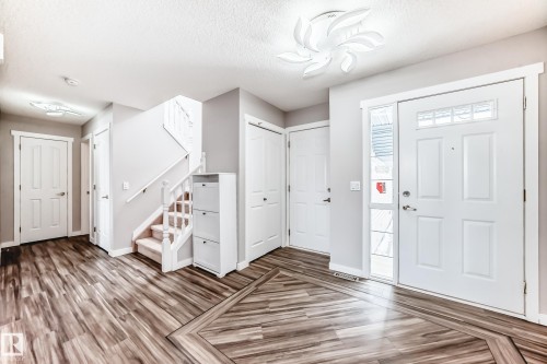 Entrance foyer featuring light wood-type flooring and a textured ceiling - 3208 29 Avenue, Edmonton, AB - Indoor Photo Showing Other Room