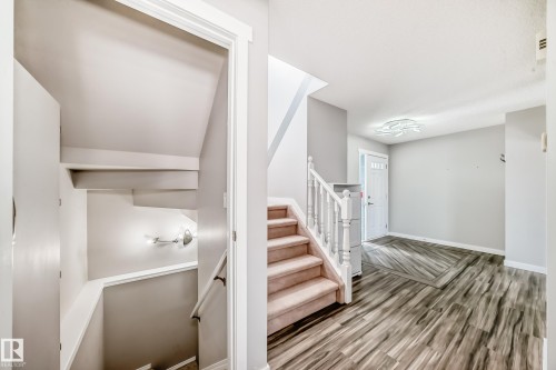 Stairway with wood finished floors and baseboards - 3208 29 Avenue, Edmonton, AB - Indoor Photo Showing Other Room