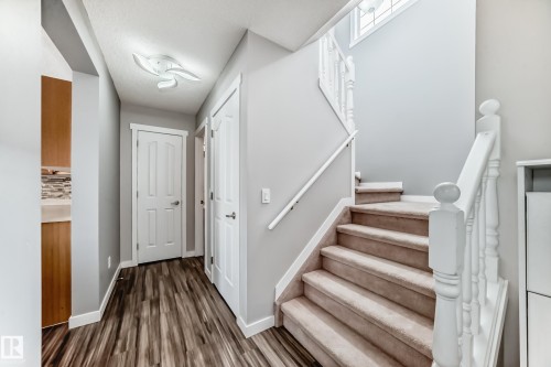 Stairway featuring baseboards and wood finished floors - 3208 29 Avenue, Edmonton, AB - Indoor Photo Showing Other Room