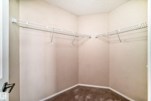 Walk in closet featuring dark carpet - 3208 29 Avenue, Edmonton, AB - Indoor With Storage