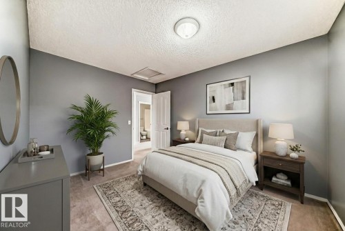 Bedroom with light carpet and a textured ceiling - 3208 29 Avenue, Edmonton, AB - Indoor Photo Showing Bedroom