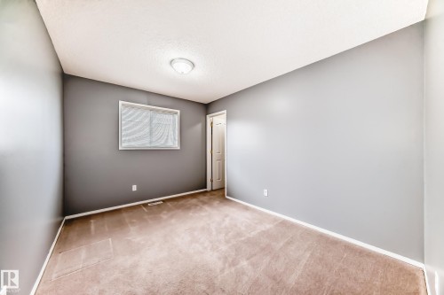 Unfurnished room with light carpet and a textured ceiling - 3208 29 Avenue, Edmonton, AB - Indoor Photo Showing Other Room