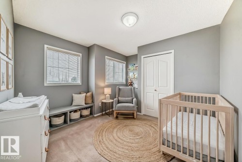 Bedroom with a crib, light carpet, and a closet - 3208 29 Avenue, Edmonton, AB - Indoor Photo Showing Bedroom