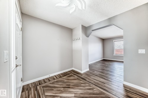 Bonus room featuring arched walkways, dark wood-type flooring, and a textured ceiling - 3208 29 Avenue, Edmonton, AB - Indoor Photo Showing Other Room