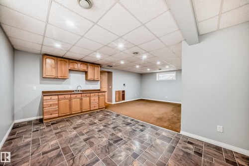 Kitchen with a paneled ceiling, dark countertops, recessed lighting, open floor plan, and wood finish cabinetry - 3208 29 Avenue, Edmonton, AB - Indoor