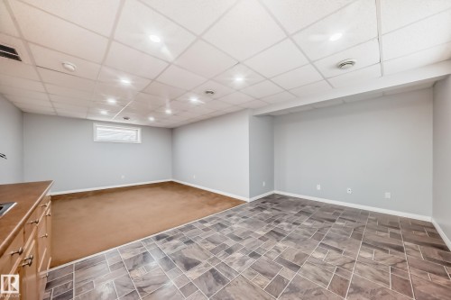 Basement featuring a drop ceiling and dark carpet - 3208 29 Avenue, Edmonton, AB - Indoor