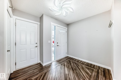 Entryway with dark wood-style flooring and a textured ceiling - 3208 29 Avenue, Edmonton, AB - Indoor Photo Showing Other Room