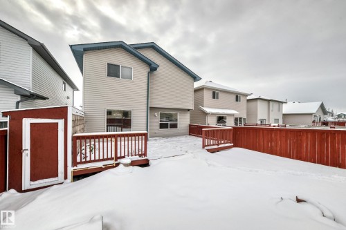 Snow covered back of property featuring a deck, a storage shed, and a residential view - 3208 29 Avenue, Edmonton, AB - Outdoor With Deck Patio Veranda With Exterior