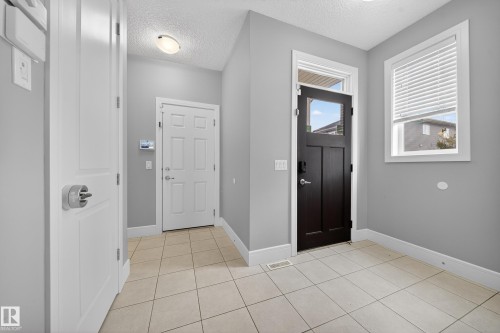Foyer entrance featuring a textured ceiling and light tile patterned flooring - 1907 Adamson Terrace, Edmonton, AB - Indoor Photo Showing Other Room