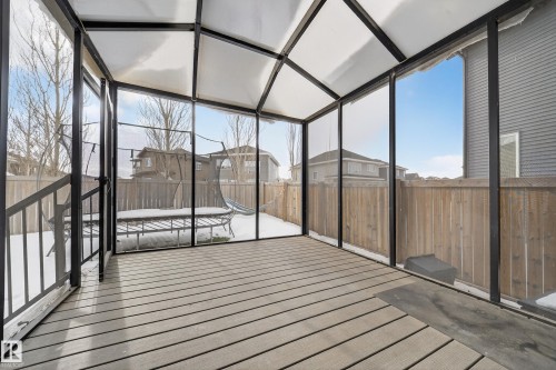 Unfurnished sunroom featuring plenty of natural light, a residential view, and vaulted ceiling - 1907 Adamson Terrace, Edmonton, AB - Indoor Photo Showing Other Room