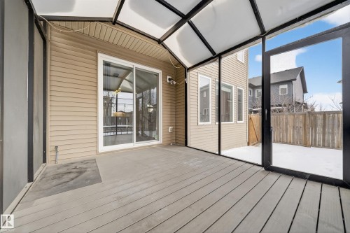 Unfurnished sunroom featuring a deck, vaulted ceiling, and plenty of natural light - 1907 Adamson Terrace, Edmonton, AB - Outdoor With Deck Patio Veranda With Exterior