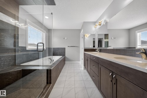 Bathroom with a garden tub, double vanity, a stall shower, and a textured ceiling - 1907 Adamson Terrace, Edmonton, AB - Indoor Photo Showing Bathroom