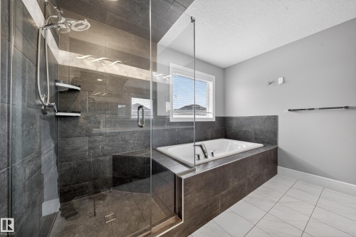 Full bathroom with a stall shower, a bath, and a textured ceiling - 1907 Adamson Terrace, Edmonton, AB - Indoor Photo Showing Bathroom