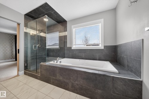Bathroom with a shower stall and a bath - 1907 Adamson Terrace, Edmonton, AB - Indoor Photo Showing Bathroom