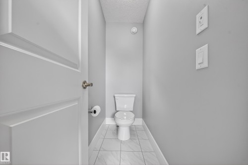 Bathroom featuring a textured ceiling and toilet - 1907 Adamson Terrace, Edmonton, AB - Indoor Photo Showing Bathroom