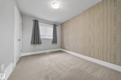Unfurnished room with light carpet and a textured ceiling - 1907 Adamson Terrace, Edmonton, AB - Indoor Photo Showing Other Room