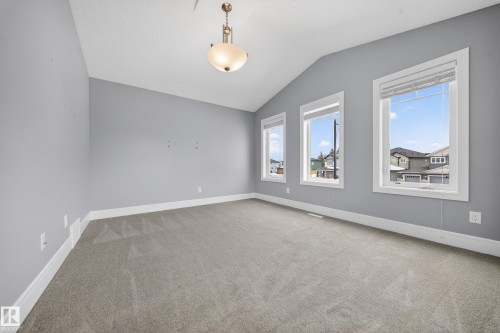 Spare room featuring lofted ceiling and light carpet - 1907 Adamson Terrace, Edmonton, AB - Indoor Photo Showing Other Room