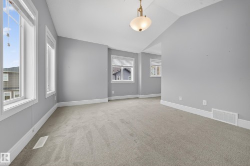 Unfurnished room featuring lofted ceiling and light carpet - 1907 Adamson Terrace, Edmonton, AB - Indoor Photo Showing Other Room