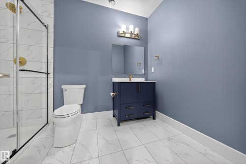 Bathroom featuring vanity, a marble finish shower, and light marble finish flooring - 1907 Adamson Terrace, Edmonton, AB - Indoor Photo Showing Bathroom