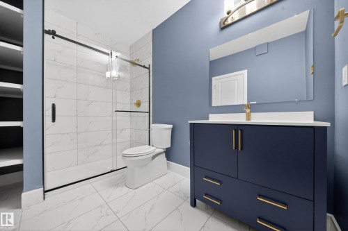 Bathroom featuring vanity, a marble finish shower, and light marble finish floors - 1907 Adamson Terrace, Edmonton, AB - Indoor Photo Showing Bathroom