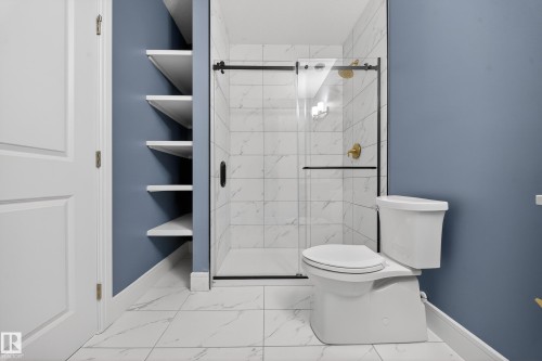 Bathroom with a stall shower and light marble finish floors - 1907 Adamson Terrace, Edmonton, AB - Indoor Photo Showing Bathroom