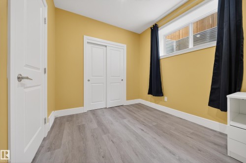 Unfurnished bedroom with light wood-style flooring and a closet - 1907 Adamson Terrace, Edmonton, AB - Indoor Photo Showing Other Room