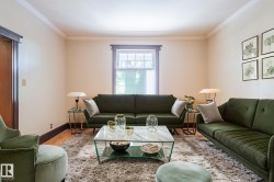 Living area with wood finished floors and crown molding - 