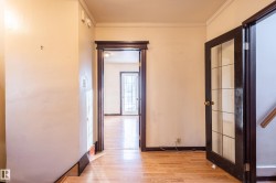 Hall featuring light wood finished floors and ornamental molding - 