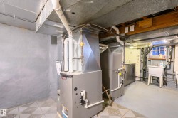 Utility room featuring heating unit and washer / clothes dryer - 