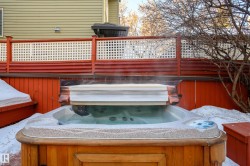 View of patio featuring a hot tub - 