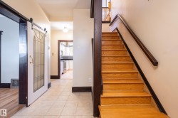 Stairway featuring a barn door and tile patterned floors - 