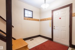 Foyer featuring light tile patterned floors and baseboards - 