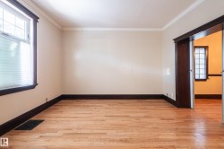 Empty room featuring healthy amount of natural light, crown molding, and light wood-type flooring - 