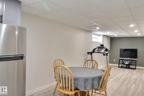 Dining room featuring a drop ceiling and light vinyl plank flooring - 4520 20A Avenue, Edmonton, AB - Indoor