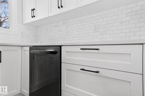 Kitchen view of white cabinetry, dishwasher, and light stone counters - 9969 171 Avenue, Edmonton, AB - Indoor