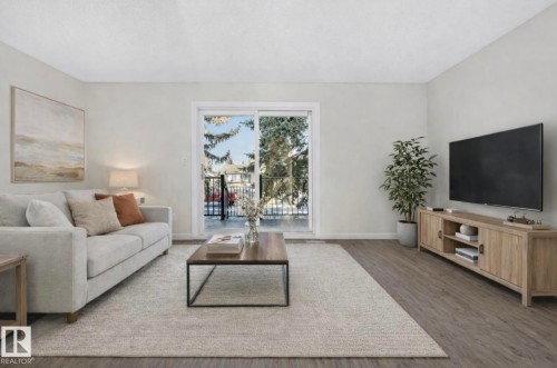 Living area featuring wood finished floors and baseboards - 9969 171 Avenue, Edmonton, AB - Indoor Photo Showing Living Room
