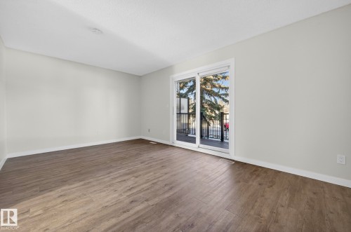Empty room featuring dark wood-style flooring and baseboards - 9969 171 Avenue, Edmonton, AB - Indoor Photo Showing Other Room