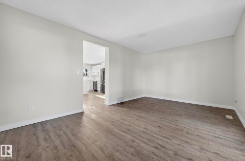 Spare room with dark wood-type flooring and a textured ceiling - 9969 171 Avenue, Edmonton, AB - Indoor Photo Showing Other Room