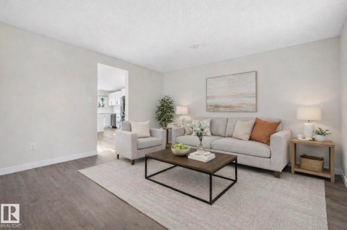Living room featuring wood finished floors and a textured ceiling - 9969 171 Avenue, Edmonton, AB - Indoor Photo Showing Living Room