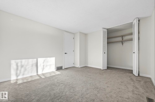 Unfurnished bedroom featuring carpet flooring and a closet - 9969 171 Avenue, Edmonton, AB - Indoor Photo Showing Other Room