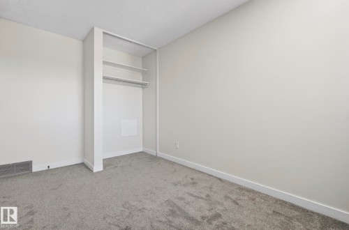 Unfurnished bedroom featuring light colored carpet and a textured ceiling - 9969 171 Avenue, Edmonton, AB - Indoor Photo Showing Other Room