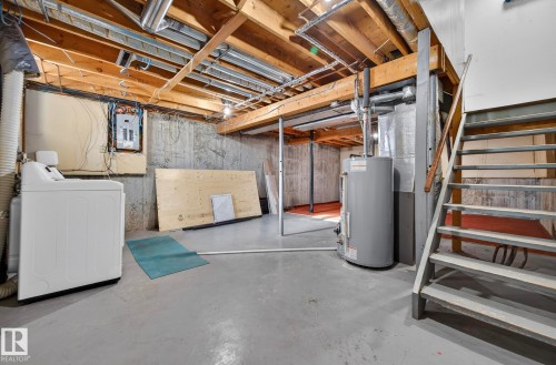 Unfinished basement with gas water heater, washer / clothes dryer, and electric panel - 9969 171 Avenue, Edmonton, AB - Indoor Photo Showing Basement