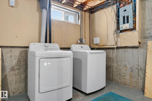Laundry area with electric panel, concrete floors, and washing machine and dryer - 9969 171 Avenue, Edmonton, AB - Indoor Photo Showing Laundry Room