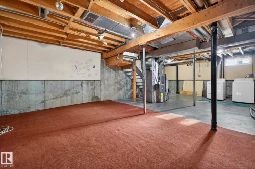 Unfinished below grade area featuring washer / dryer, heating unit, and water heater - 9969 171 Avenue, Edmonton, AB - Indoor Photo Showing Basement