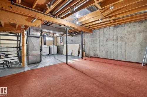 Below grade area featuring heating unit and washing machine and clothes dryer - 9969 171 Avenue, Edmonton, AB - Indoor Photo Showing Basement