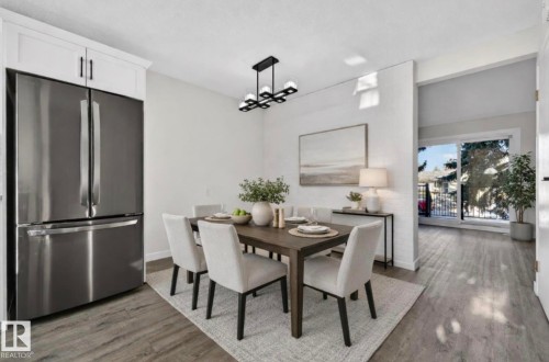Dining space with dark wood-type flooring and suspended lighting - 9969 171 Avenue, Edmonton, AB - Indoor Photo Showing Dining Room