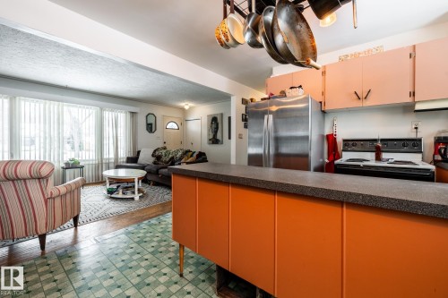 Kitchen and living room in a bright open concept space - 12231 47 Street, Edmonton, AB - Indoor Photo Showing Kitchen