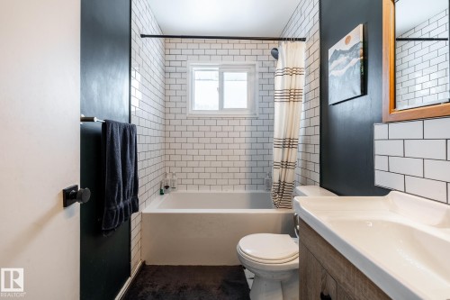 Full bathroom with vanity and shower/bath combo with shower curtain - 12231 47 Street, Edmonton, AB - Indoor Photo Showing Bathroom