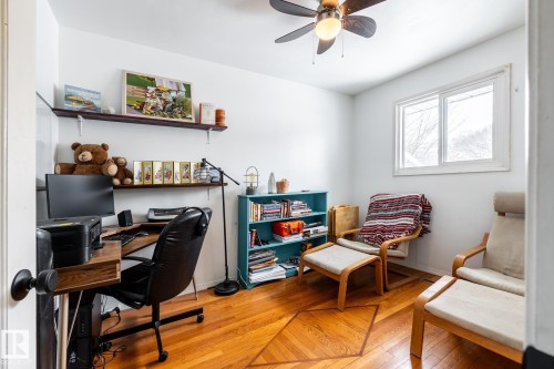 Second bedroom also serves as a home office with light flooring and ceiling fan - 12231 47 Street, Edmonton, AB - Indoor Photo Showing Office
