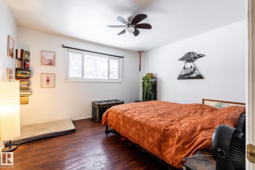 Primary bedroom featuring dark flooring and a ceiling fan - 12231 47 Street, Edmonton, AB - Indoor Photo Showing Bedroom